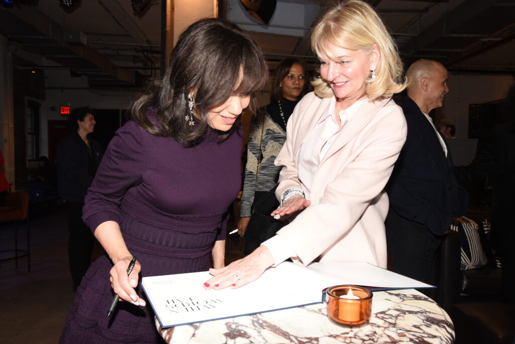 Pamela Thomas-Graham signing first edition copies of When Words Fail, New York twilight photography book