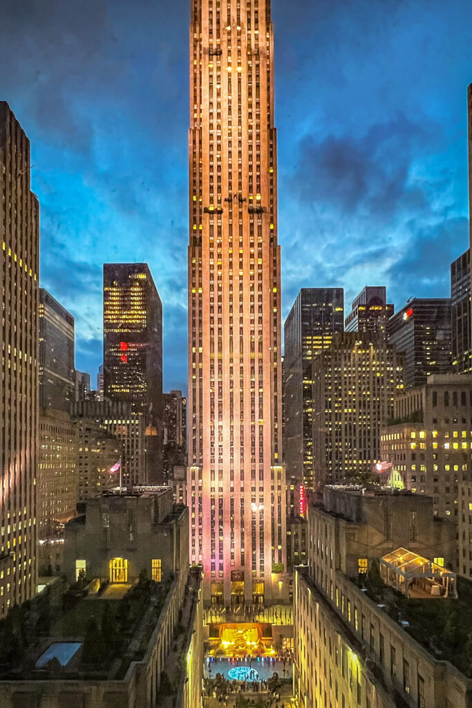 Rockefeller Center plaza at dusk with golden light.