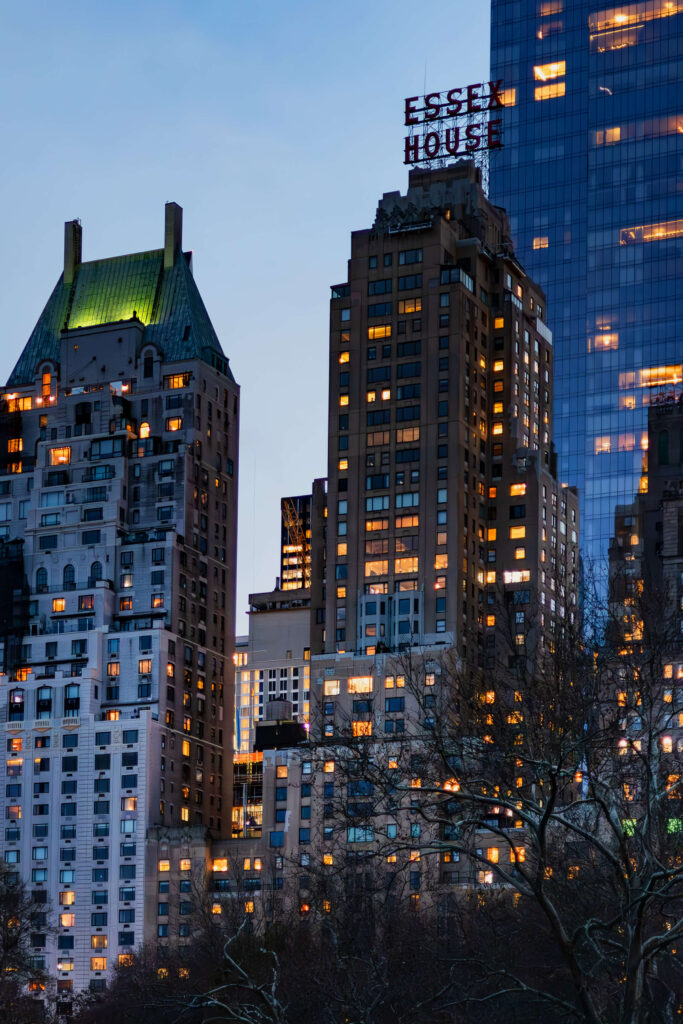 Eleven-print indigo-and-gold gallery wall featuring New York twilight photographs by Pamela Thomas-Graham.